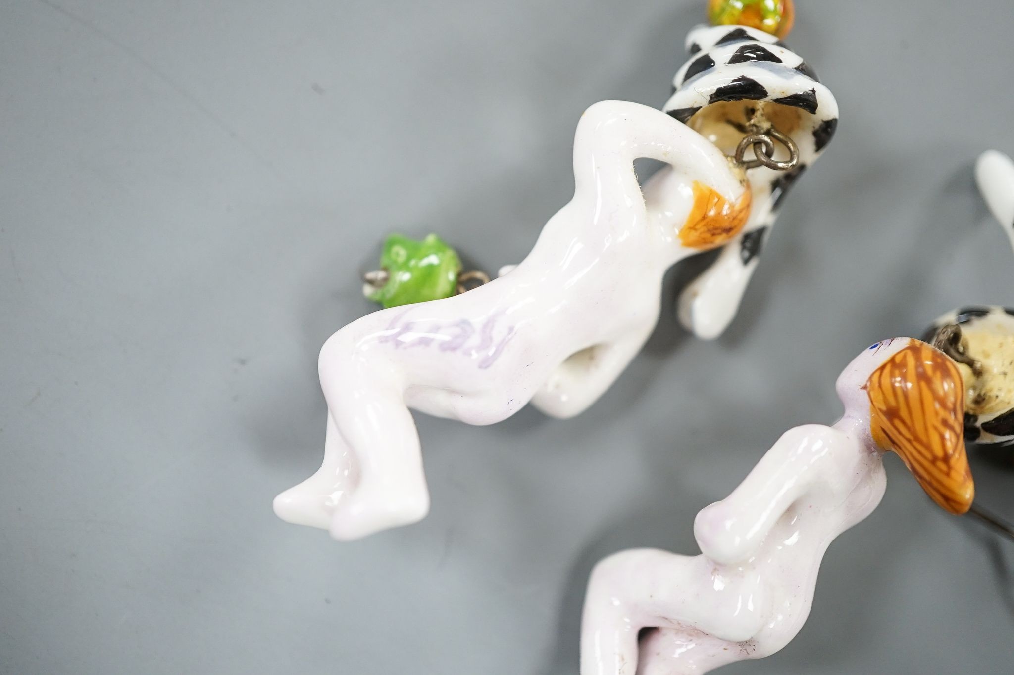 A pair of painted porcelain 'Adam & Eve with serpent' drop earrings, 62mm